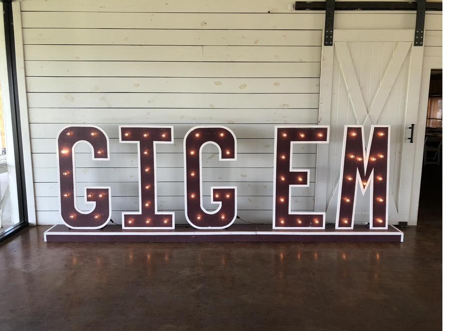 GIG 'EM marquee letters at a barn venue